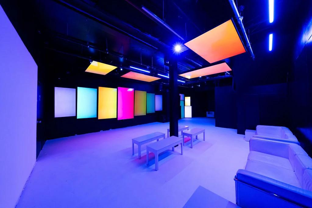 Basement lounge with its screen wall and color light panels, empty