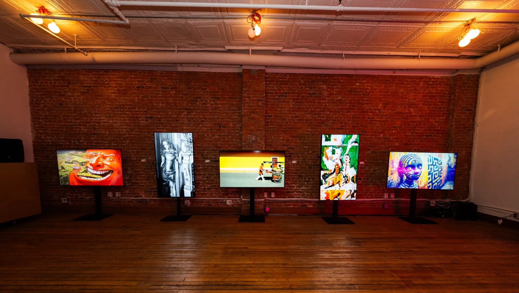 Screens along the brick wall of the loft