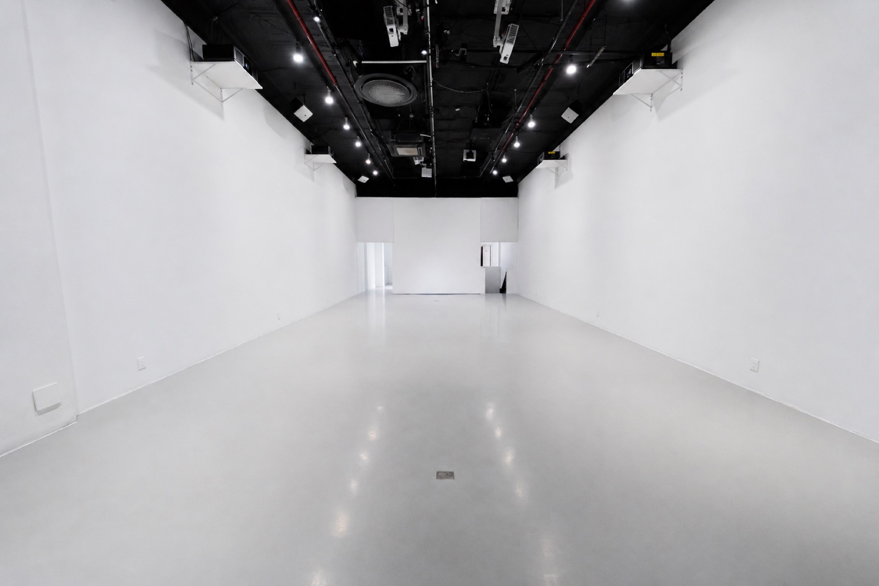The White Box Stage empty, white walls end to end under the black ceiling