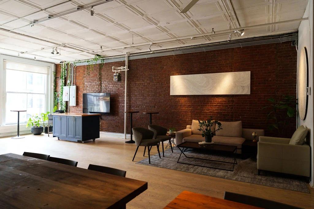 Living room set with a wall-mounted display, the dining loft beyond