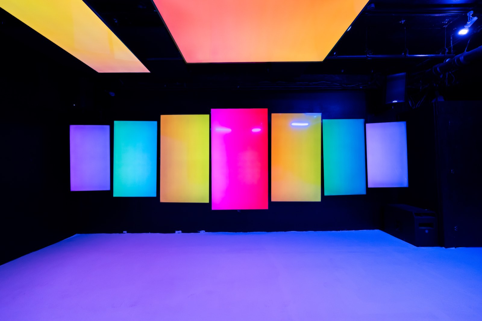 Basement lounge with a wall of color screens