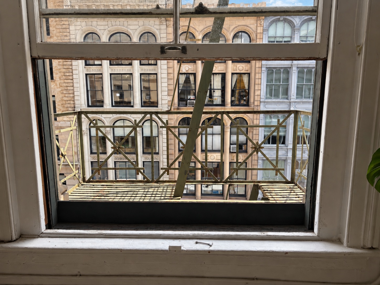 The fire escape seen from inside the 4th-floor loft through the open window
