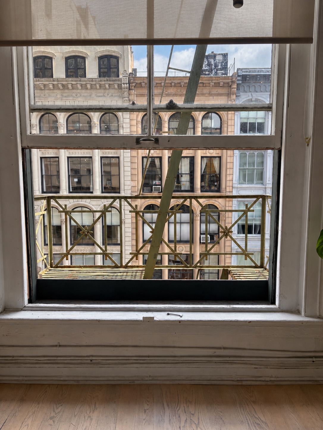 Window view onto the fire escape platform from the 4th-floor loft floor