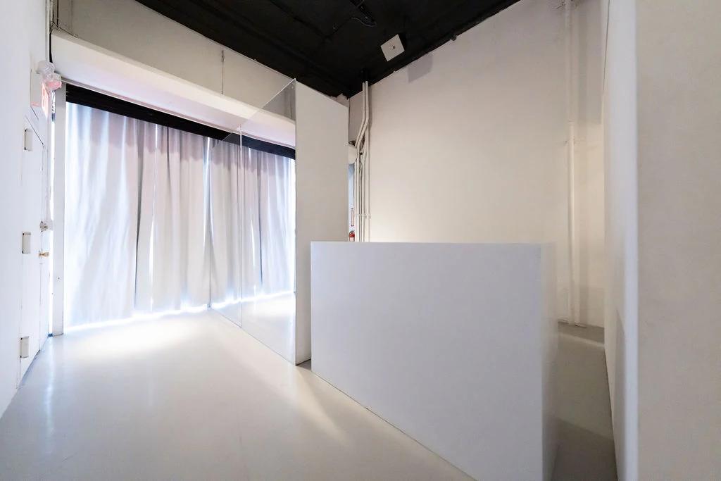 White curtain entry and clean white walls